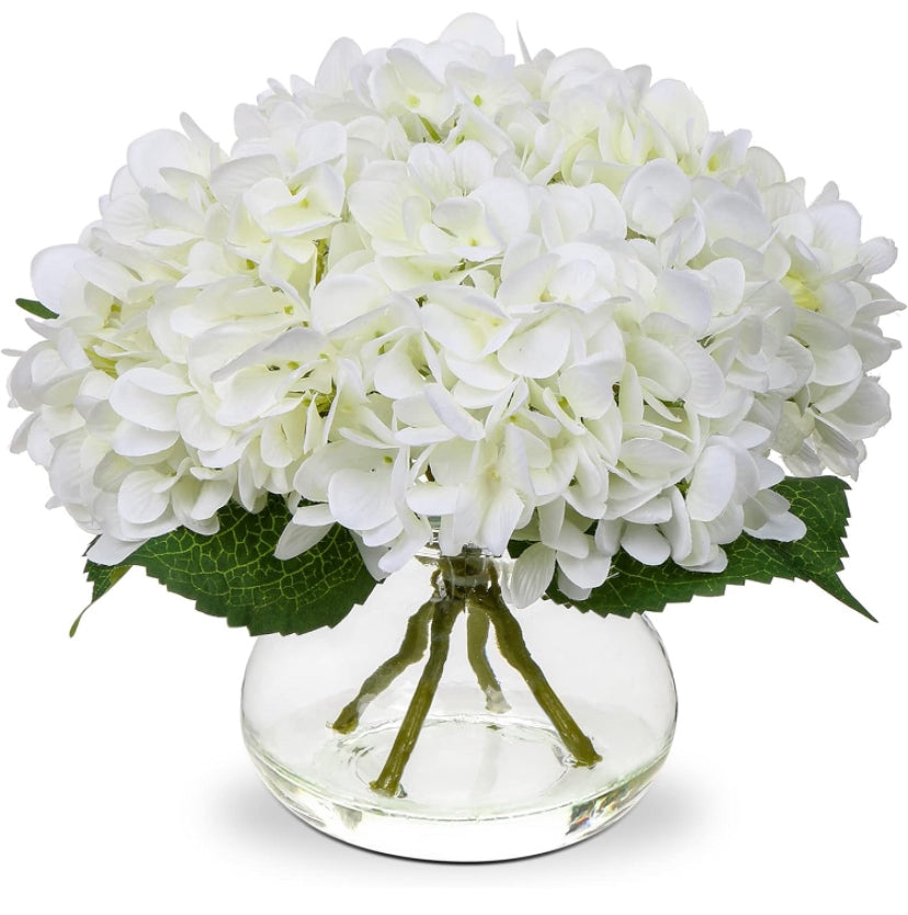 Artificial flowers in glass vase